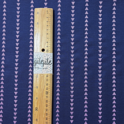 Close-up of indigo blue and lilac yarn dyed dobby triangle stripe woven cotton fabric showing raised vertical mini triangle texture — reversible cut direction 135gsm slow fashion dressmaking fabric UK
