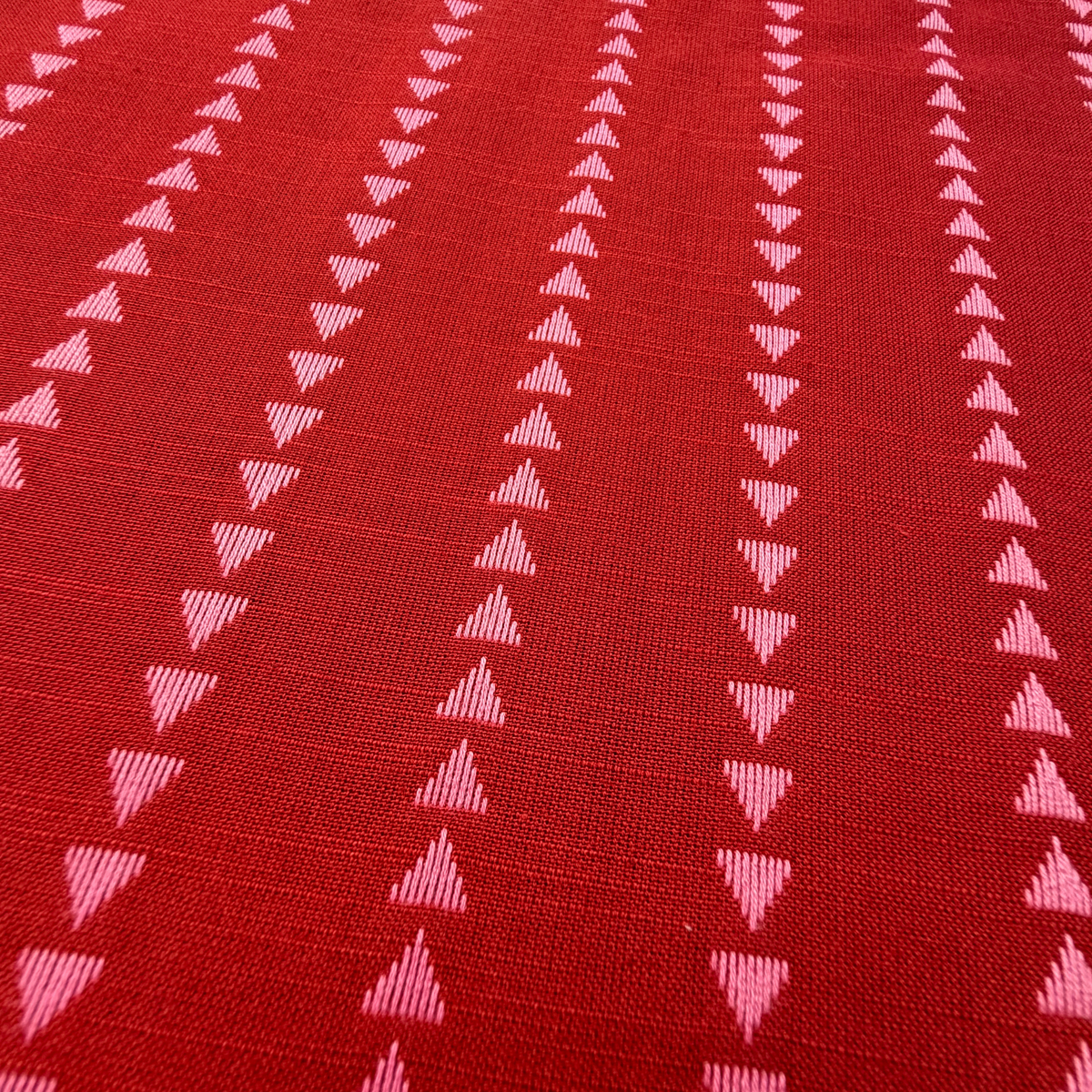 Close-up of indigo blue and lilac yarn dyed dobby triangle stripe woven cotton fabric showing raised vertical mini triangle texture — reversible cut direction 135gsm slow fashion dressmaking fabric UK