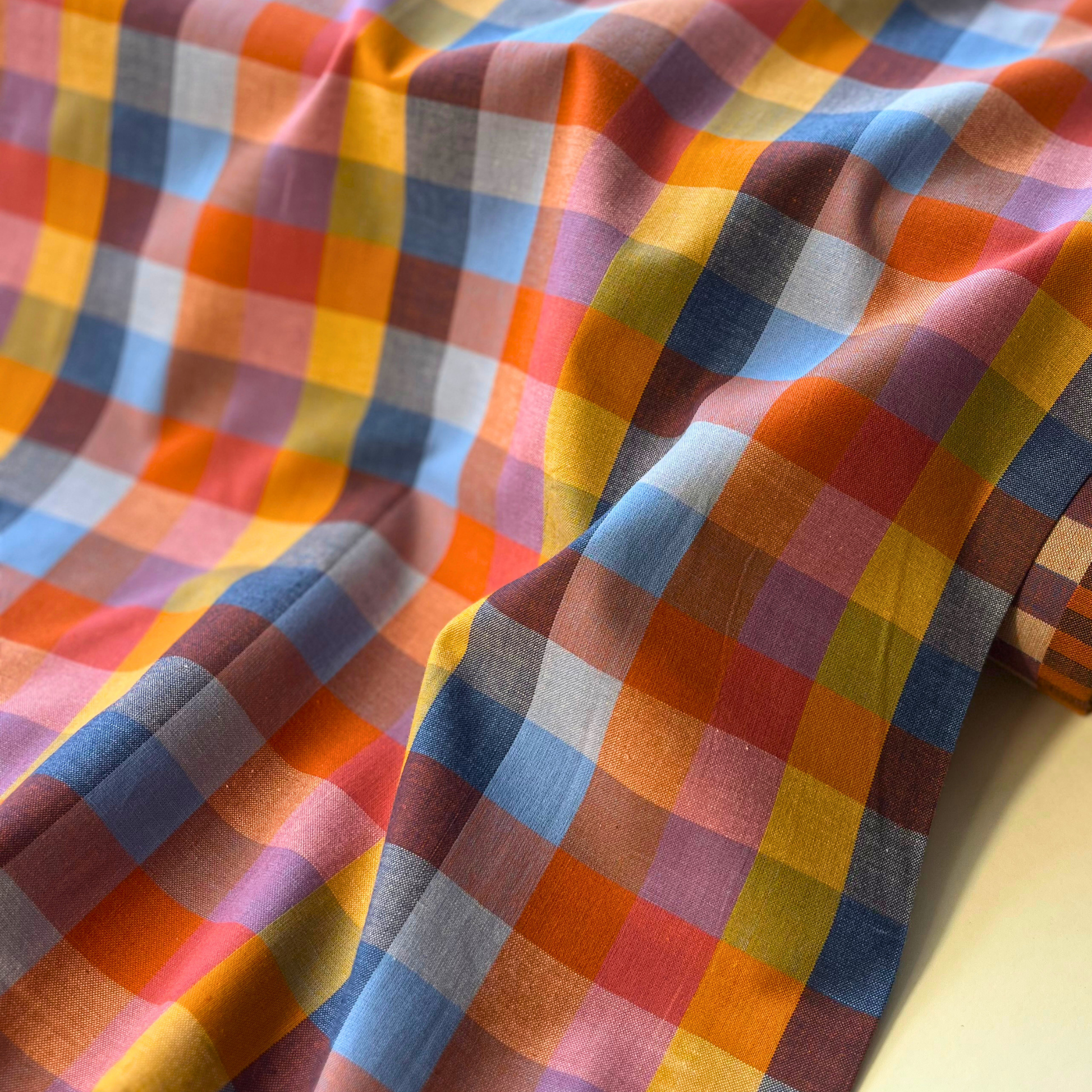 Fableism Cornucopia Happy Checkers multicolour gingham woven cotton fabric folded to show bold 3cm check construction — 110cm wide lightweight dressmaking fabric in yellow orange blue and pink for handmade dresses and blouses