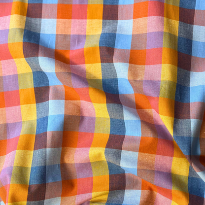 Close-up of Fableism Fine and Dandy Cornucopia Happy Checkers woven cotton fabric showing 3cm multicolour gingham check in yellow orange blue and pink — lightweight 135gsm slow fashion dressmaking fabric UK