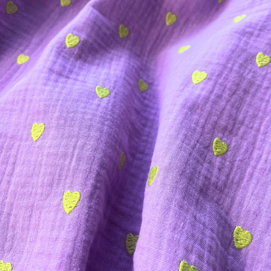 Lavender embroidered double gauze fabric with small scattered neon yellow heart embroidery, 135cm wide — 140gsm 100% cotton two-layer woven, Oeko-Tex Standard 100 certified for handmade summer dresses, children's clothing and baby muslins