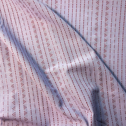 Lilac and burgundy dobby stripe yarn dyed woven cotton fabric folded to show raised vertical dot and dash texture — 145cm wide lightweight dressmaking fabric for handmade blouses shirts autumn dresses and skirts