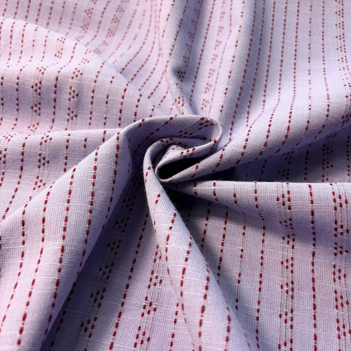 Lilac and burgundy yarn dyed dobby stripe woven cotton fabric vertical dot and dash pattern — 135gsm 100% cotton textured woven for slow fashion dressmaking children's clothing and autumnal transitional makes