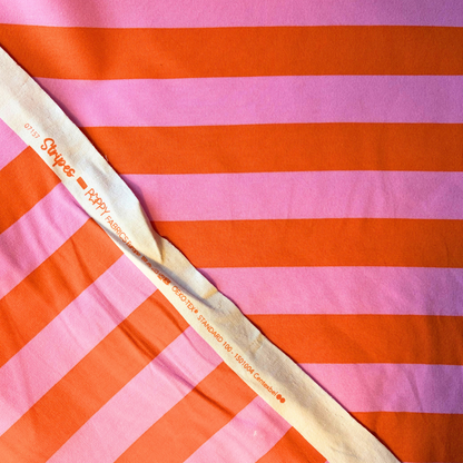 Orange pink wide stripe sweatshirting folded to show soft brushed interior and bold horizontal stripe — 148cm wide 225gsm cotton elastane Oeko-Tex certified stretch fabric for handmade sweatshirts and children's clothing