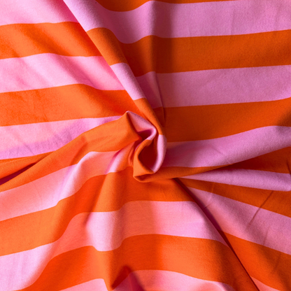 Orange pink wide stripe brushed sweatshirting flat lay showing 225gsm weight and 148cm width — bold horizontal stripe stretch fabric perfect for handmade sweatshirts hoodies and children's tops