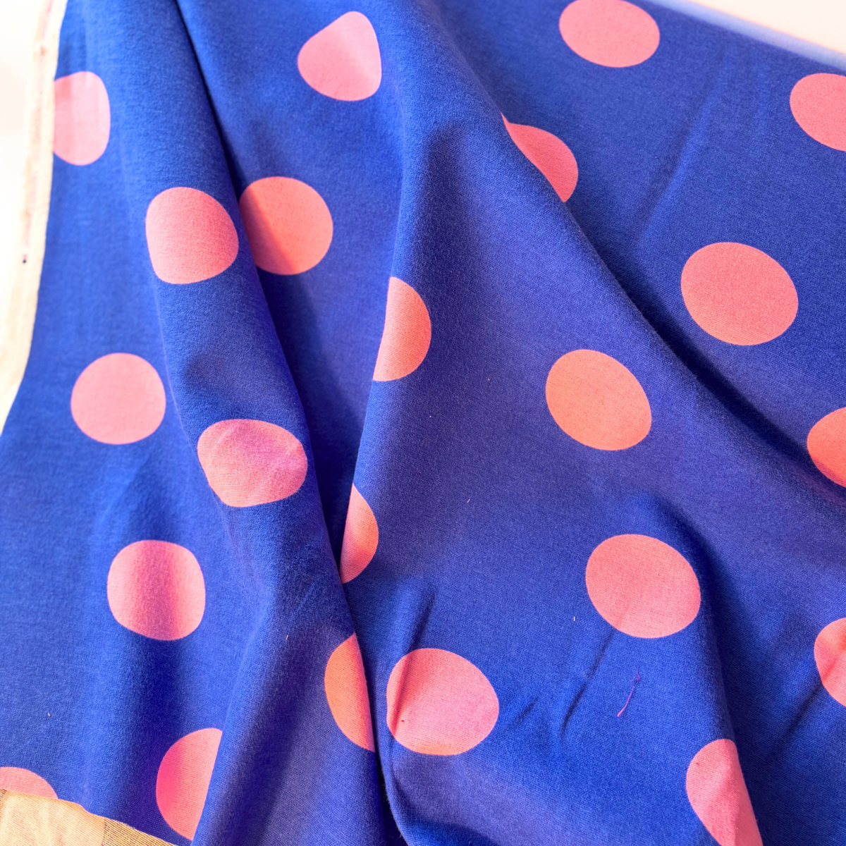 Pink polka dot cobalt blue flannel fabric flat lay showing 165gsm weight and 143cm width — brushed woven cotton perfect for handmade shirts blouses dresses and transitional autumn makes