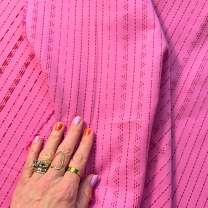 Bright pink lilac dobby stripe cotton fabric flat lay showing 135gsm natural drape and generous 145cm width — yarn dyed vertical dot dash woven stripe perfect for handmade blouses dresses and transitional makes