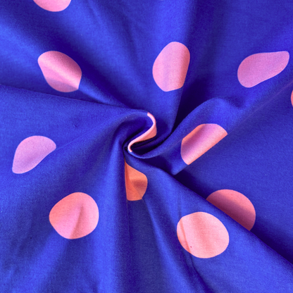 Pink polka dot flannel fabric on cobalt blue base 143cm wide — 165gsm brushed woven 100% cotton Oeko-Tex certified for handmade shirts dresses and skirts