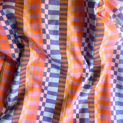Close-up of Fableism Fine and Dandy broken stripe woven cotton fabric in orange multicolour showing jacquard-like texture and depth — heavyweight 240gsm dressmaking fabric ideal for dresses and trousers