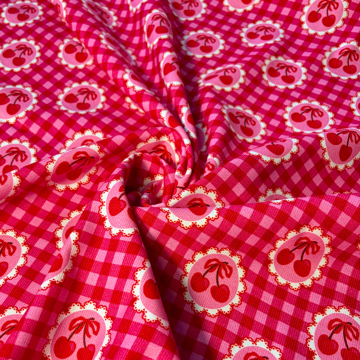 Red and pink gingham needlecord fabric with cherry motifs in circular frames 112cm wide, 125gsm 100% cotton corduroy for handmade trousers pinafores jackets and soft furnishings