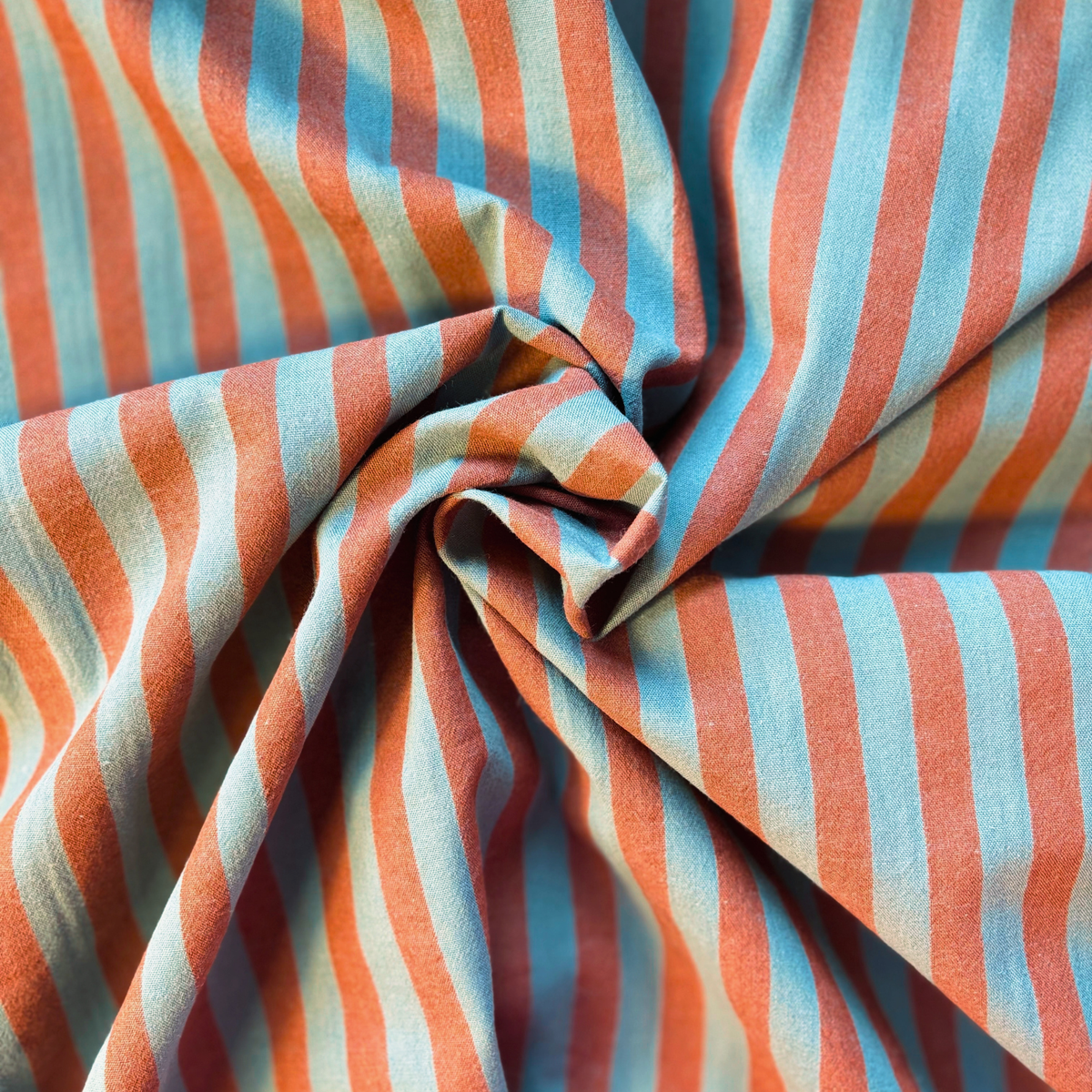 Washed brown teal yarn dyed stripe cotton fabric flat lay showing 115gsm natural drape and 145cm width — earthy tonal stripe perfect for handmade blouses wide-leg trousers and relaxed dresses