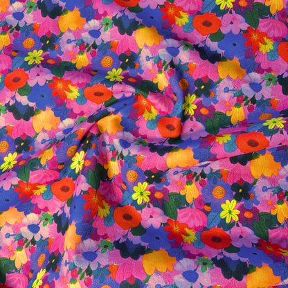 Wildflower Symphony floral needlecord fabric flat lay showing 125gsm weight and 112cm width, cotton corduroy with all-over flower head print perfect for handmade pinafores trousers and jackets
