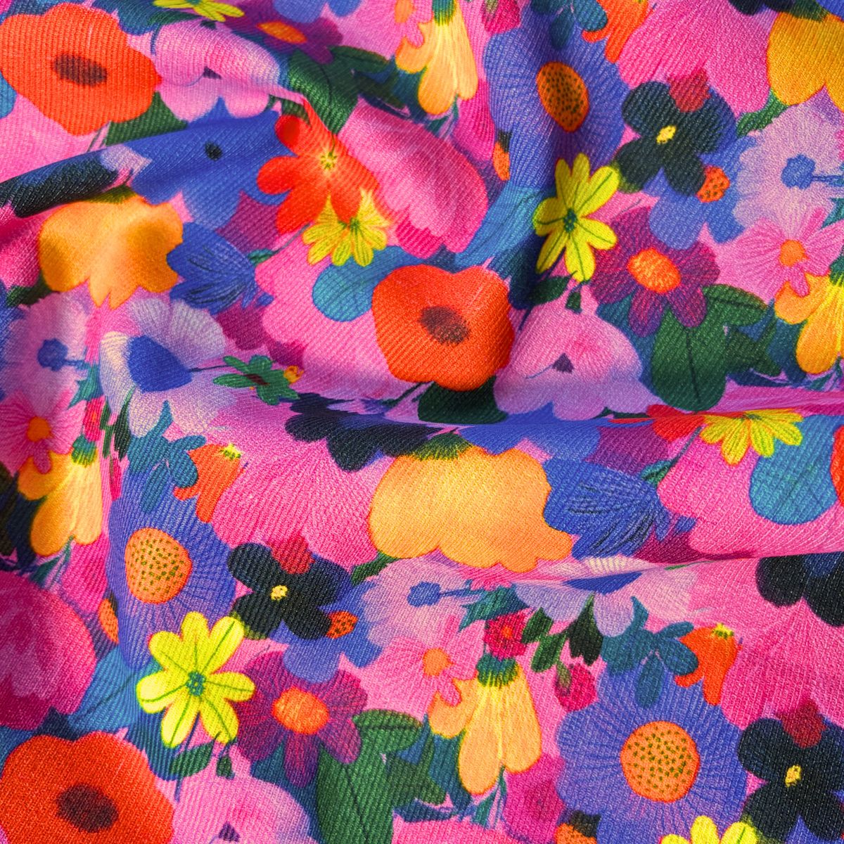 Wildflower Symphony needlecord fabric with bright floral print of closely packed flower heads 112cm wide, 125gsm 100% cotton corduroy for handmade trousers pinafores jackets and soft furnishings