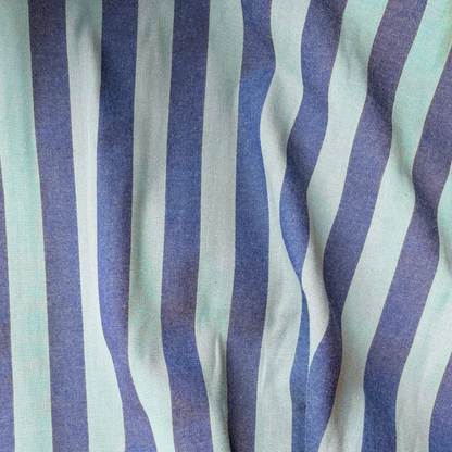 Close-up of blue and teal green yarn dyed vertical stripe cotton fabric — crisp 2.2cm stripe definition 135gsm woven Oeko-Tex Standard 100 certified slow fashion dressmaking fabric UK