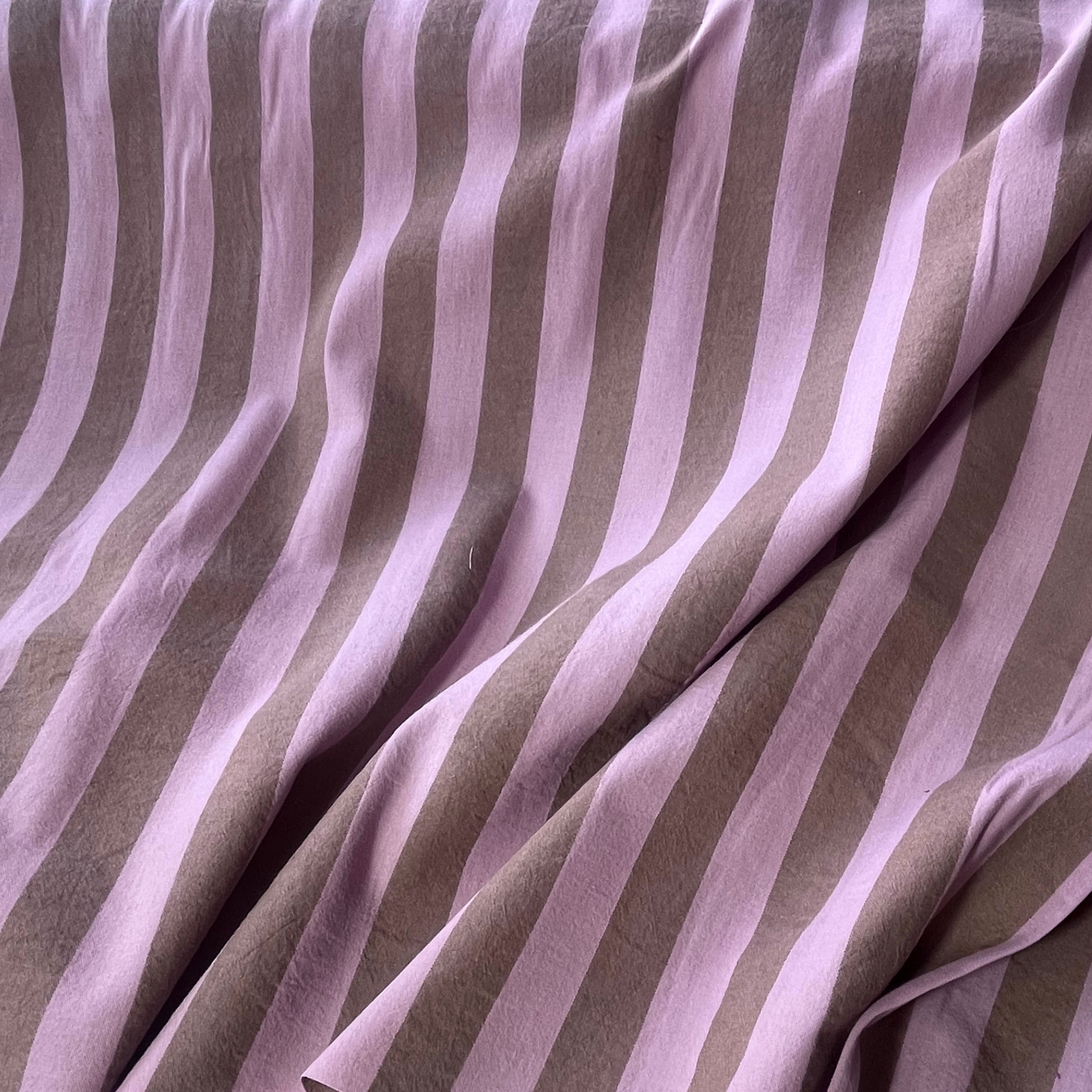 Close-up of pale pink light brown yarn dyed vertical stripe cotton fabric — crisp 3cm stripe definition 135gsm woven Oeko-Tex Standard 100 certified slow fashion dressmaking fabric UK